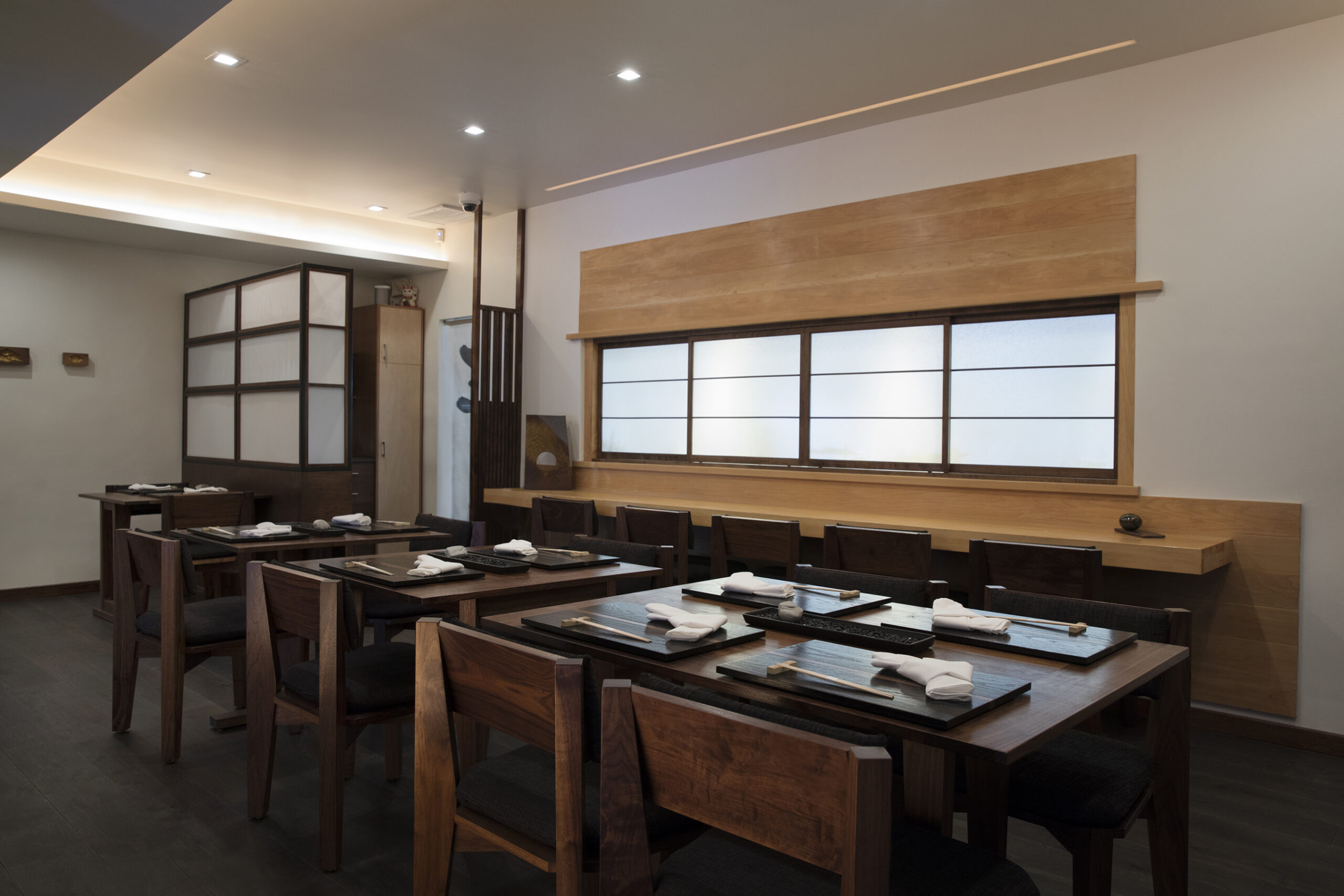 interior shot of n/naka tables and sushi bar
